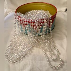 Round Merry Elf Tin Includes 40 feet of Pearlized Beaded Garland